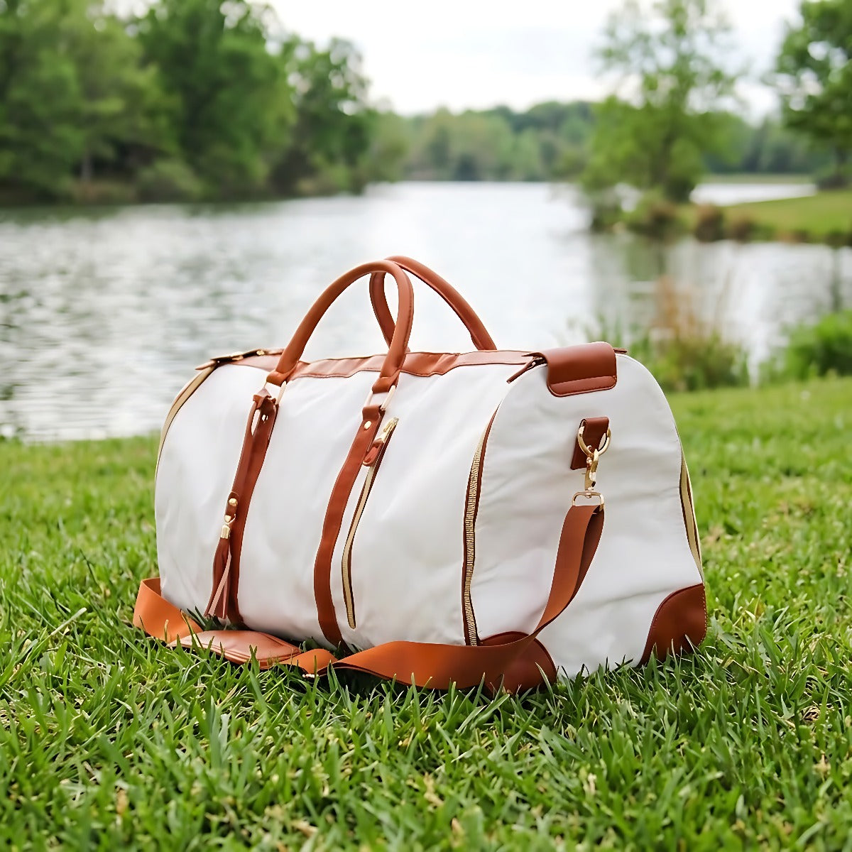 Snow travel bag on grass by a lake